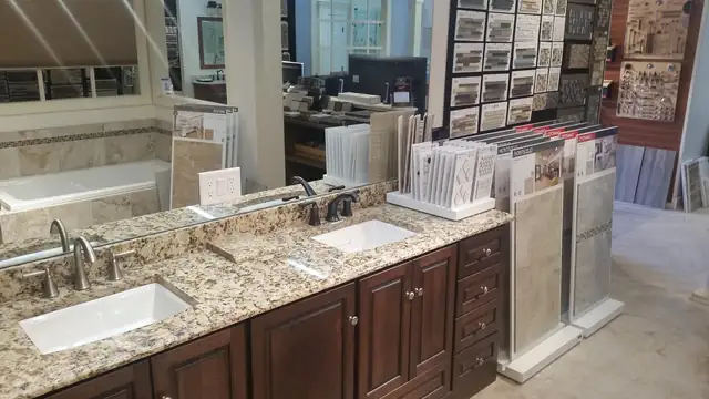 Vanity displays and tile sample racks inside The Bath Remodeling Center design center in downtown Cary