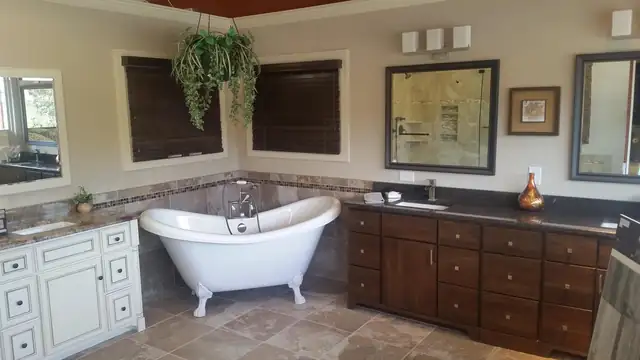Raleigh bathroom with clawfoot tub, custom wood and white bath cabinets and tile wainscot